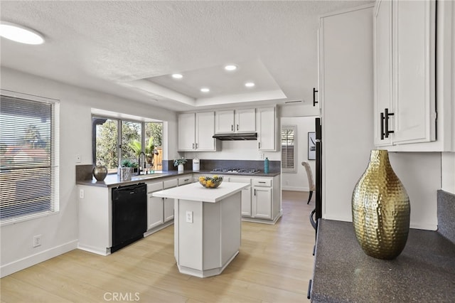 kitchen featuring dishwasher, a center island, white cabinets, sink, and light hardwood / wood-style flooring