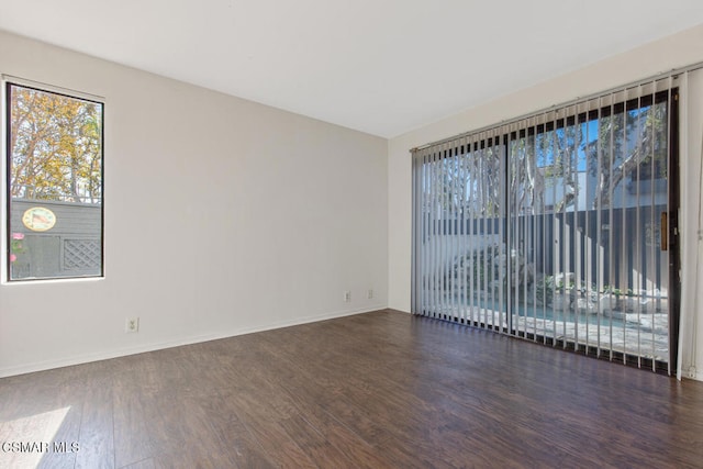 spare room with dark wood-type flooring