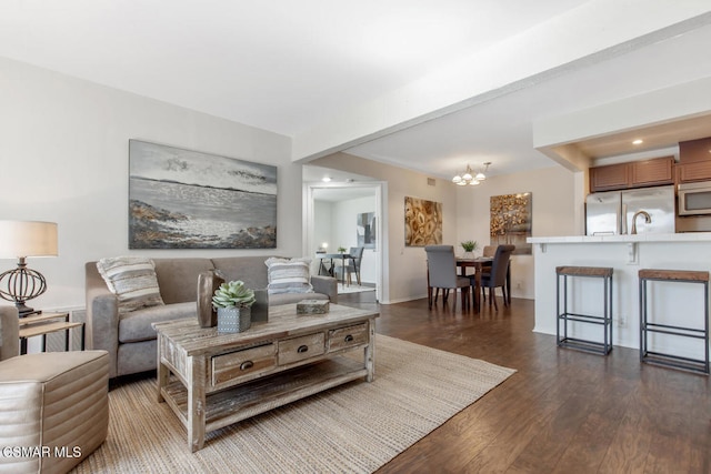 living room featuring dark wood-type flooring and an inviting chandelier