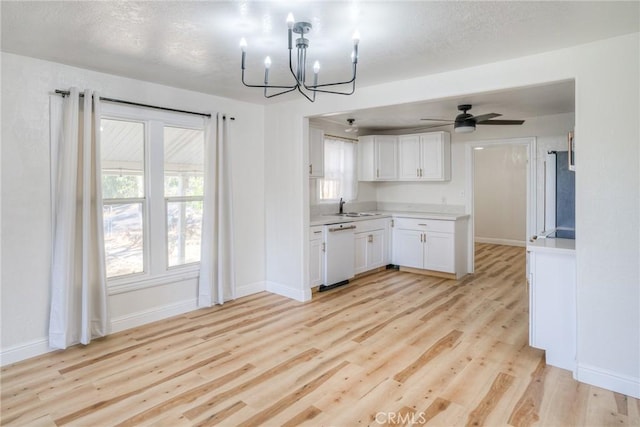 kitchen with white cabinetry, dishwasher, light hardwood / wood-style floors, and ceiling fan with notable chandelier