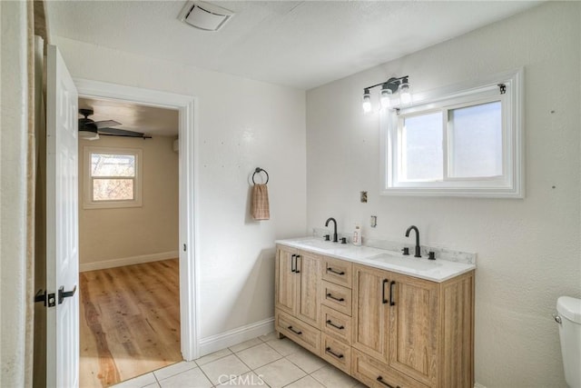 bathroom with a textured ceiling, vanity, ceiling fan, hardwood / wood-style flooring, and toilet