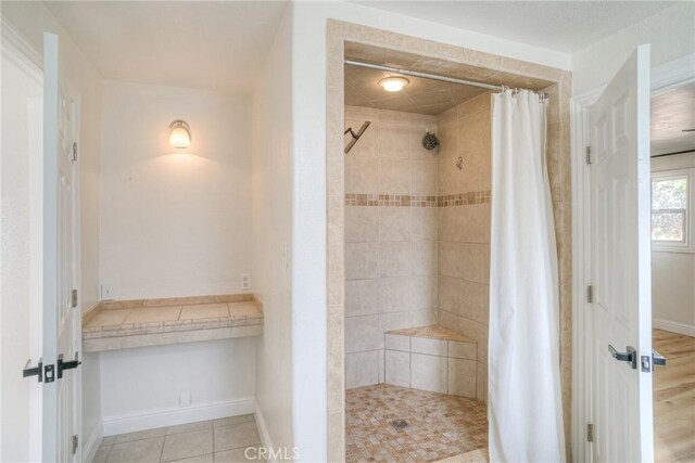 bathroom featuring a shower with curtain and tile patterned floors