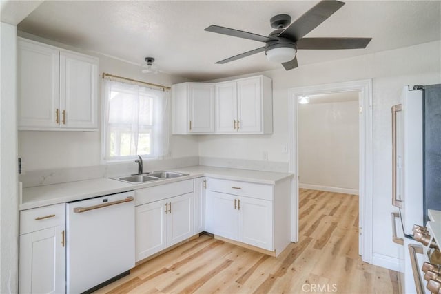 kitchen featuring white cabinets, light wood-type flooring, and white appliances