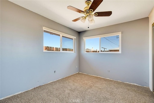 unfurnished room featuring carpet flooring and ceiling fan