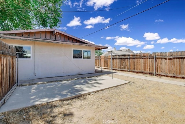 view of side of property featuring a patio area