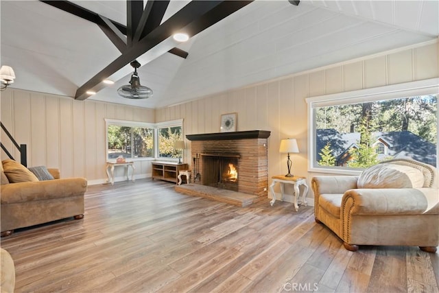 sitting room with hardwood / wood-style floors and lofted ceiling with beams