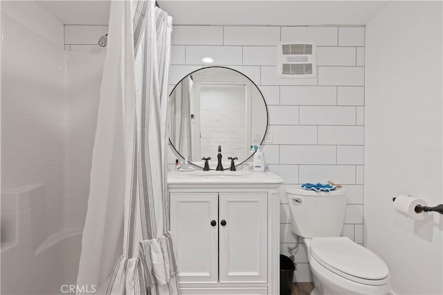 full bathroom with toilet, tile walls, shower / tub combo, and vanity