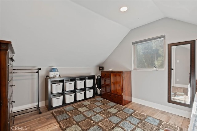 additional living space with lofted ceiling and light hardwood / wood-style flooring