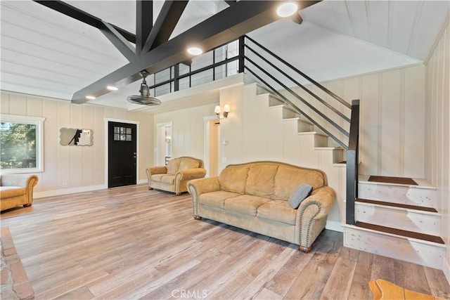 living room featuring vaulted ceiling and light hardwood / wood-style floors