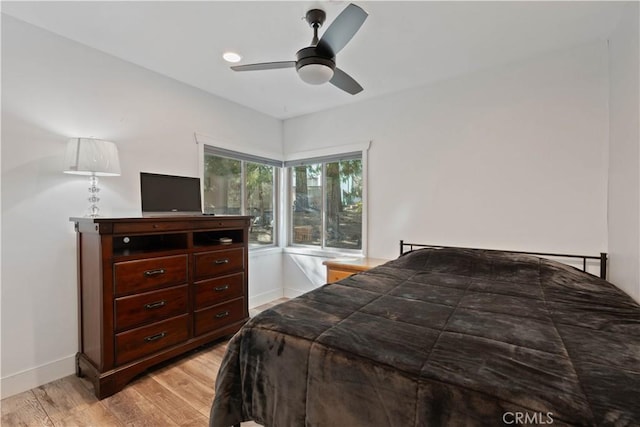 bedroom with ceiling fan and light hardwood / wood-style floors