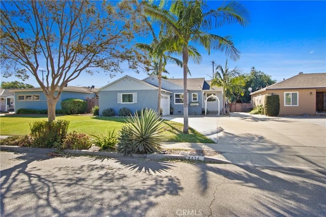 ranch-style house featuring a garage and a front yard