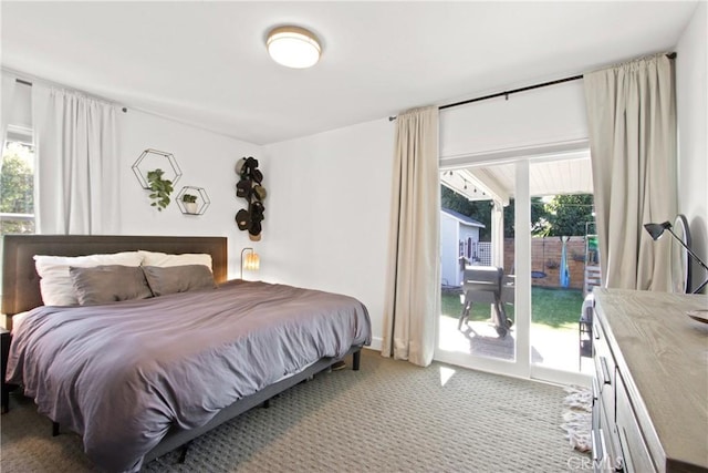 carpeted bedroom featuring multiple windows and access to outside