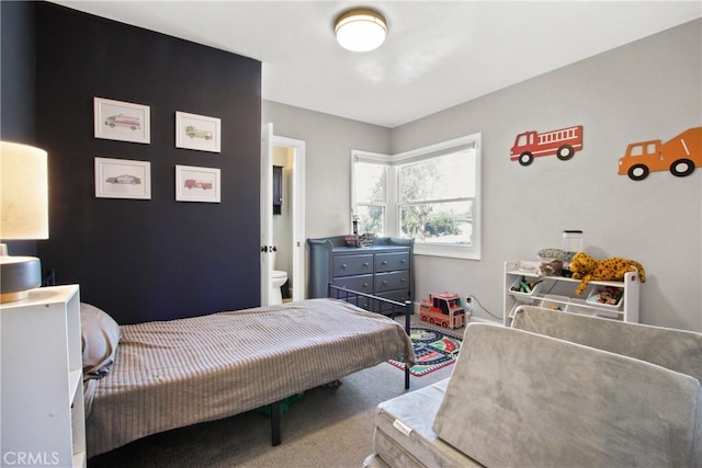 carpeted bedroom featuring connected bathroom