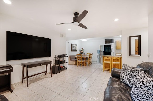 living room featuring ceiling fan and light tile patterned flooring