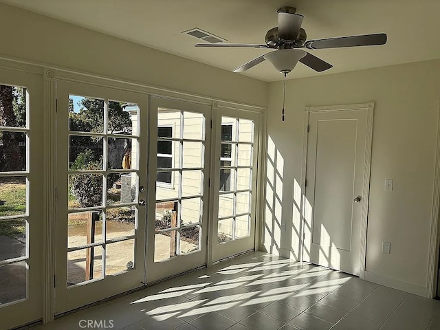 doorway to outside featuring ceiling fan and plenty of natural light