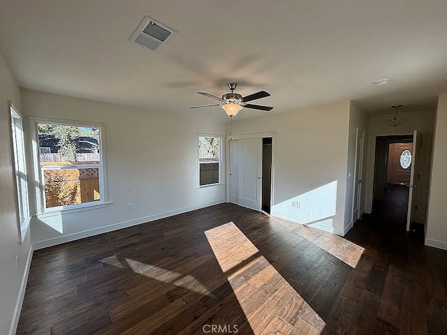 spare room featuring dark hardwood / wood-style floors and ceiling fan