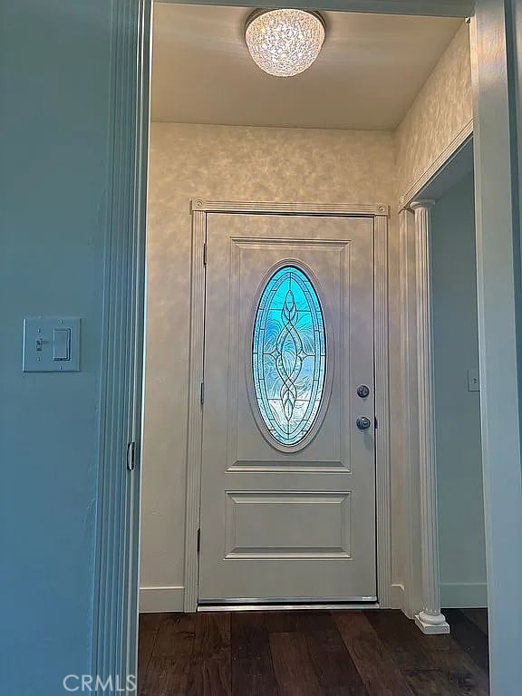 doorway to outside with dark wood-type flooring