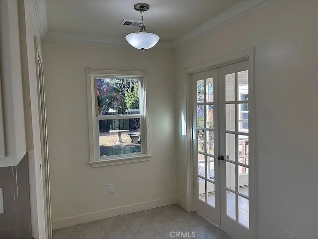 unfurnished dining area with french doors, ornamental molding, and light tile patterned flooring