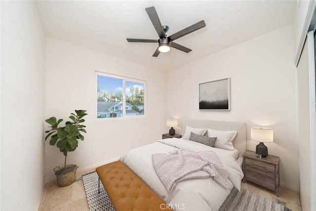 bedroom with ceiling fan and light carpet