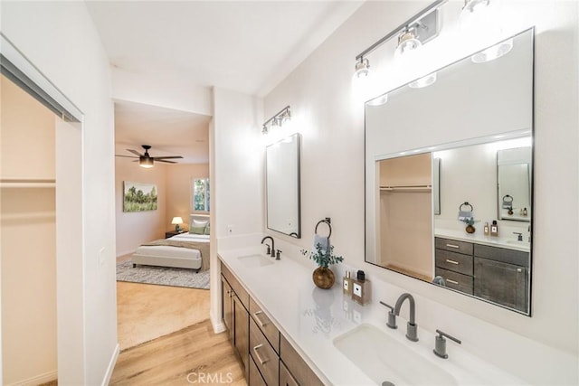 bathroom featuring wood-type flooring, vanity, and ceiling fan