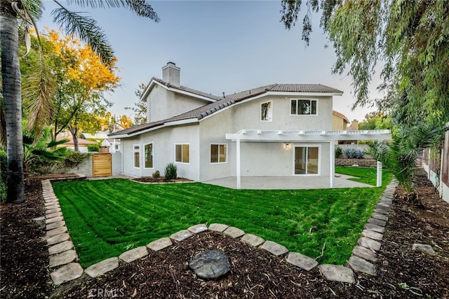 back of property with a yard and a pergola