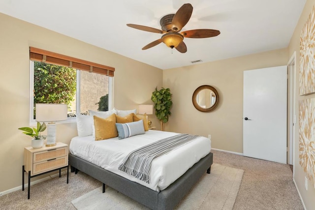 bedroom with light carpet and ceiling fan