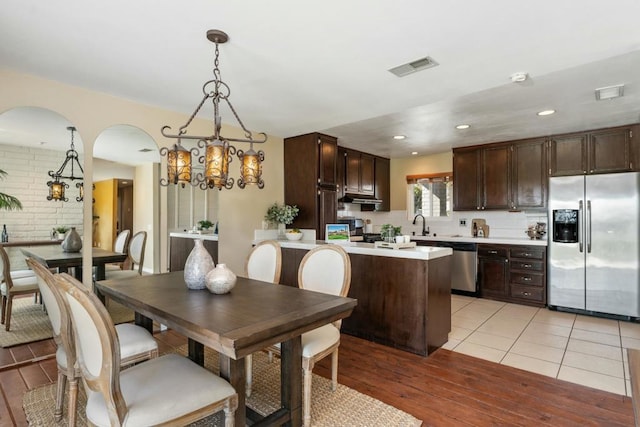 dining area featuring a chandelier and light wood-type flooring