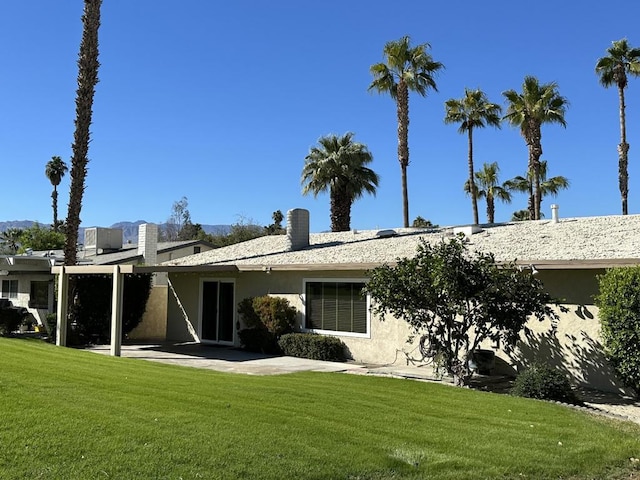 back of house featuring a yard and a patio area