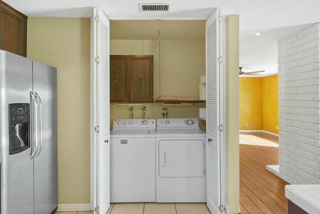 laundry area with cabinets, washer and dryer, ceiling fan, and light tile patterned flooring