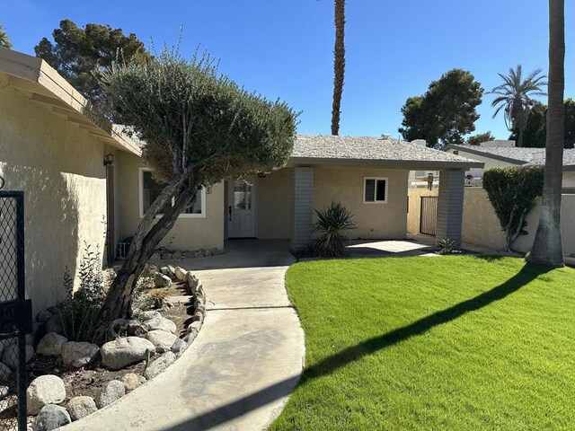 rear view of house featuring a yard