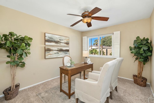 carpeted office space featuring ceiling fan