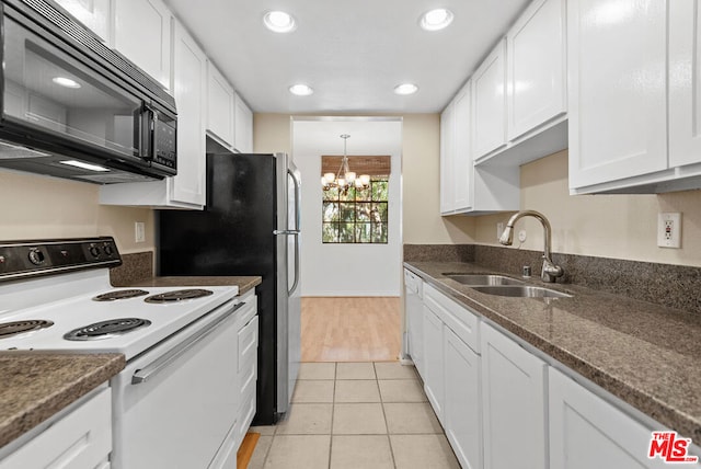 kitchen with white appliances, sink, white cabinets, a chandelier, and light tile patterned flooring