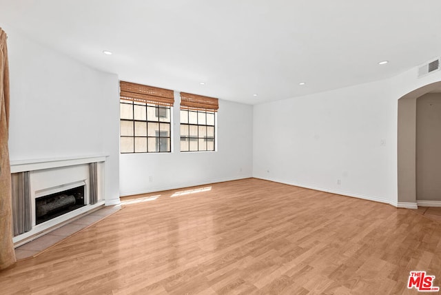 unfurnished living room with light wood-type flooring