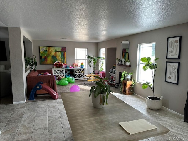 game room with a textured ceiling