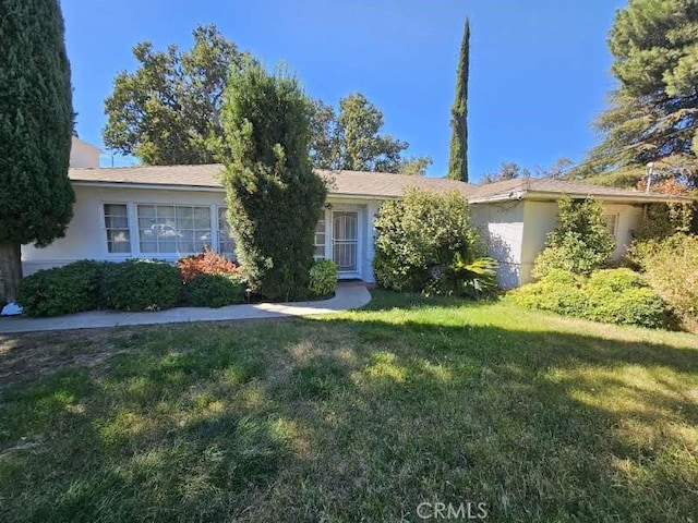 ranch-style home with a front lawn