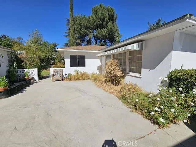 view of property exterior with a patio