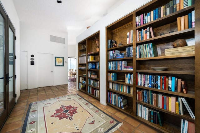 hall with tile patterned floors