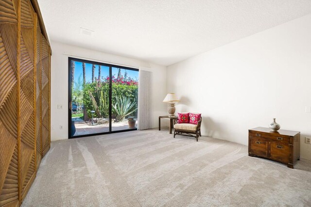 living area with light colored carpet