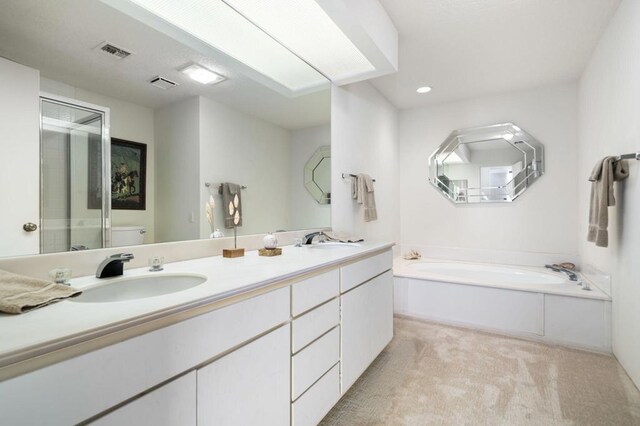 full bathroom featuring vanity, toilet, and separate shower and tub