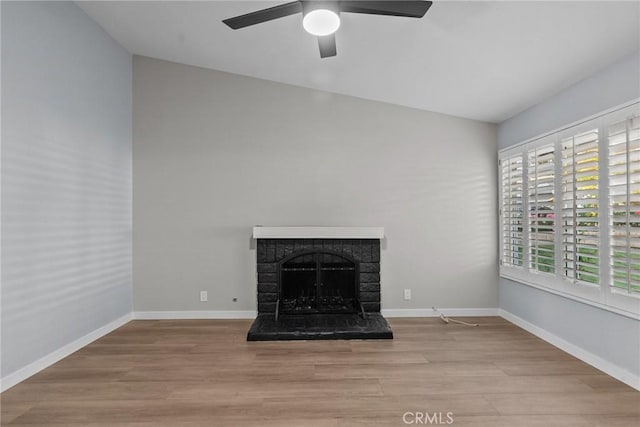 unfurnished living room with a stone fireplace, lofted ceiling, and light wood-type flooring