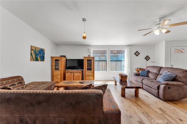 living room with light wood-type flooring and ceiling fan