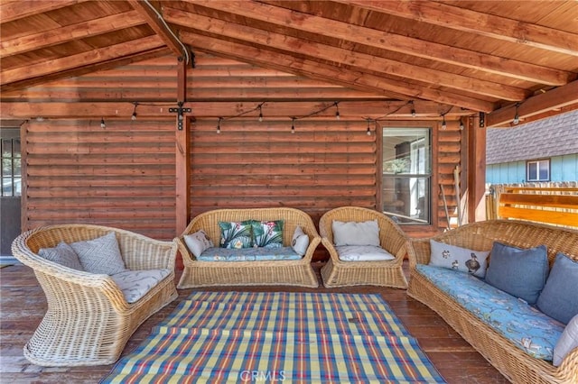 sunroom featuring plenty of natural light, lofted ceiling with beams, and wooden ceiling