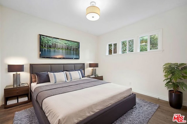 bedroom featuring dark wood-type flooring