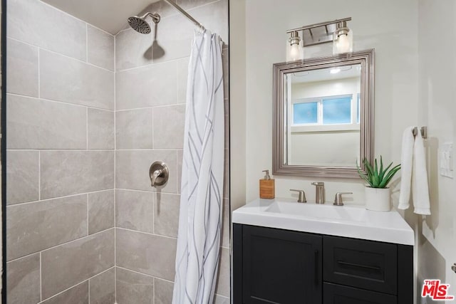 bathroom with a shower with curtain and vanity