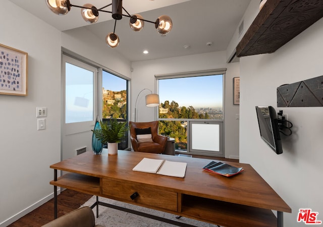 office featuring wood-type flooring and an inviting chandelier