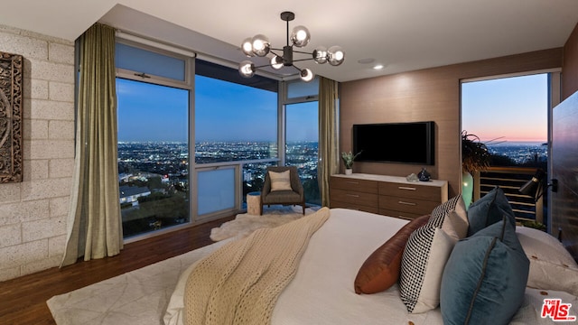 bedroom with floor to ceiling windows, a chandelier, and dark wood-type flooring