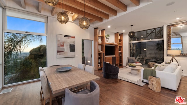 dining area with beamed ceiling and dark hardwood / wood-style flooring