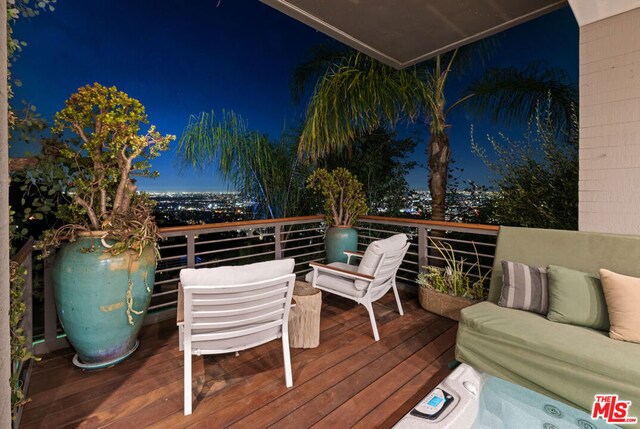 deck at night featuring an outdoor living space