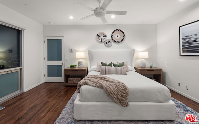 bedroom with dark hardwood / wood-style floors and ceiling fan