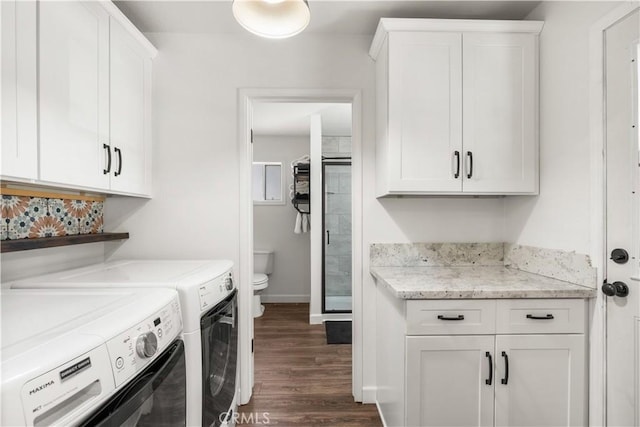 laundry area with dark hardwood / wood-style flooring, cabinets, and independent washer and dryer